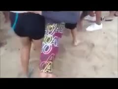 A excited horny white wife rubs her a-hole against a guy's groin on a beach